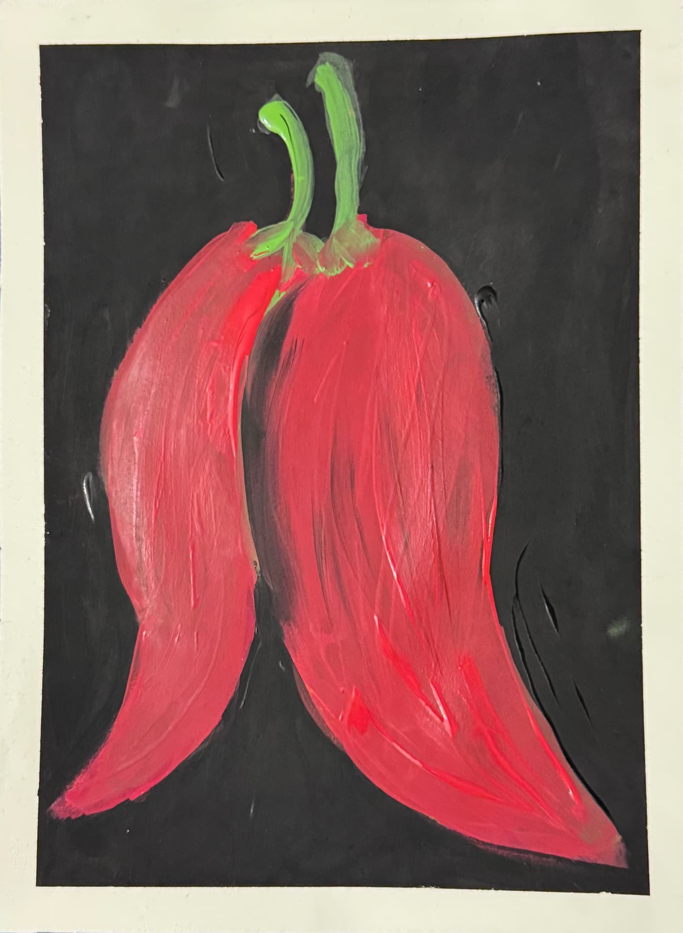 Two red chili peppers on a black background