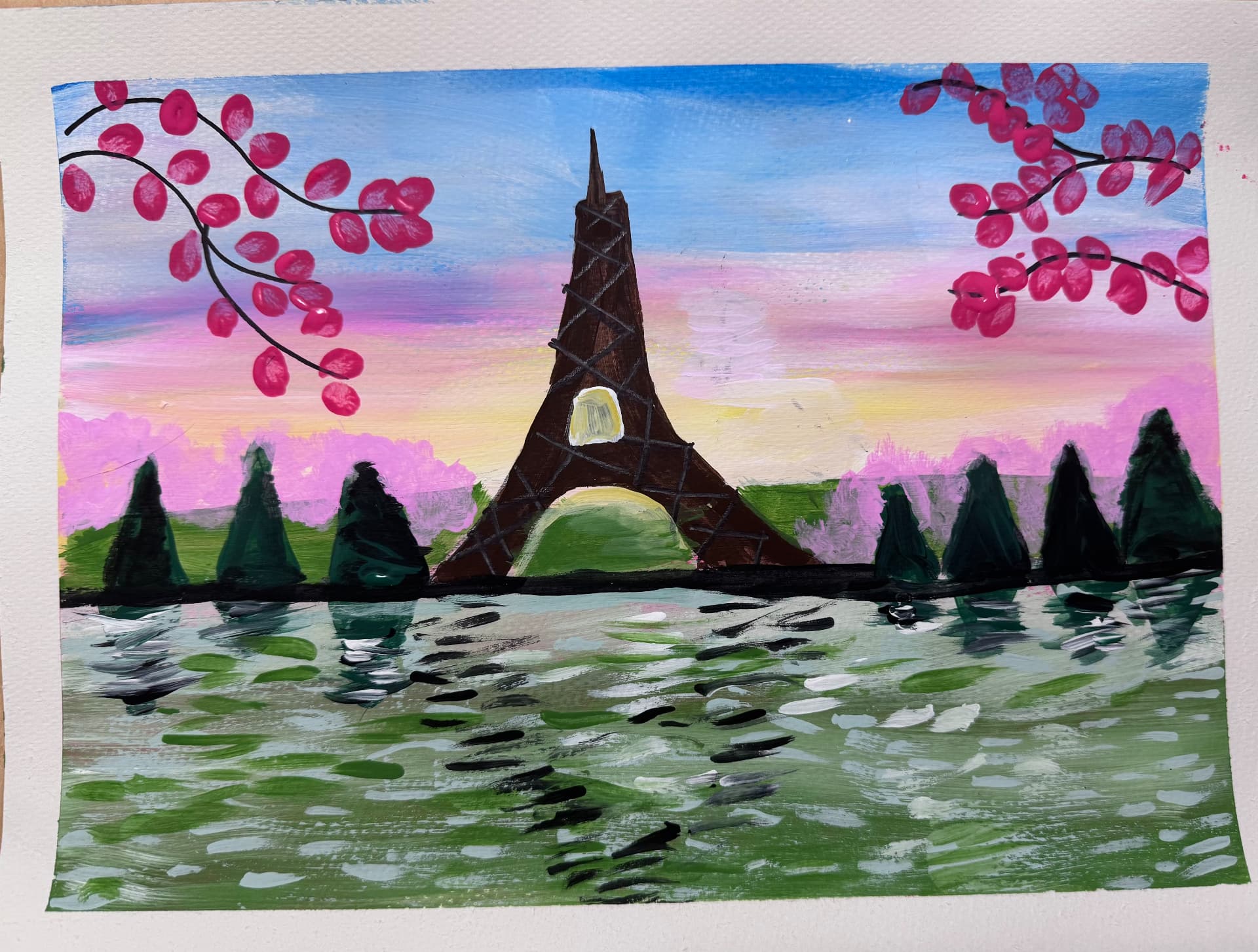Eiffel Tower at sunset framed by pink blossoms